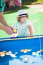 Adorable little girl fishing with her father. Royalty Free Stock Photo