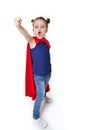 Adorable little girl flying like a superhero in blue t-shirt and red mantle. Super girl. The new generation saves the world. Good