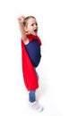 Adorable little girl flying like a superhero in blue t-shirt and red mantle. Super girl. The new generation saves the world. Good