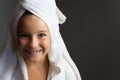 Adorable little girl happy smiling after spa bath on a white bath towel head Royalty Free Stock Photo