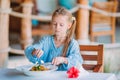 Adorable little girl having dinner at outdoor cafe Royalty Free Stock Photo