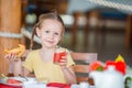 Adorable little girl having dinner at outdoor cafe Royalty Free Stock Photo