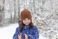 Adorable little girl having fun in beautiful winter forest. Cute child playing outdoors. Winter activities for kids Royalty Free Stock Photo