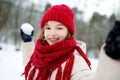 Adorable little girl having fun in beautiful winter park. Cute child playing in a snow. Royalty Free Stock Photo