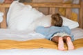 Adorable little girl having fun at home and lying in big family bead Royalty Free Stock Photo