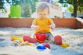 Adorable little girl having fun on playground in sandpit Royalty Free Stock Photo