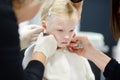 Adorable little girl having her ears pierced Royalty Free Stock Photo