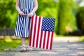 Adorable little girl holding american flag outdoors on beautiful summer day Royalty Free Stock Photo