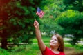 Adorable little girl holding american flag outdoors on beautiful summer day. Independence Day Royalty Free Stock Photo