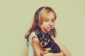 Adorable little girl holding chihuahua puppy standing. girl holding chihuahua dogs in her arms. girl 9 or 10 years