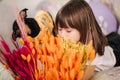 Adorable little girl hug her pet at home on sofa. Kid preparing for easter at home during quarantine. Cute dog Royalty Free Stock Photo