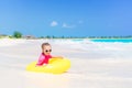 Adorable little girl with inflatable rubber circle splashing. Kid having fun on summer active vacation