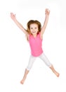 Adorable little girl jumping in air isolated