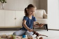 Adorable little girl kid playing with toys on warm floor Royalty Free Stock Photo