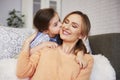 Adorable girl kissing her mommy on the cheek Royalty Free Stock Photo