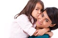 Adorable little girl kissing her mother's cheek Royalty Free Stock Photo