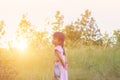 Adorable little girl laughing in a meadow - happy girl at sunset Royalty Free Stock Photo