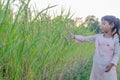 Adorable little girl laughing in a meadow - happy girl at sunset Royalty Free Stock Photo