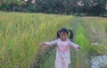 Adorable little girl laughing in a meadow - happy girl at sunset Royalty Free Stock Photo