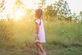 Adorable little girl laughing in a meadow - happy girl at sunset Royalty Free Stock Photo