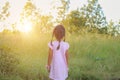 Adorable little girl laughing in a meadow - happy girl at sunset Royalty Free Stock Photo