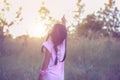 Adorable little girl laughing in a meadow - happy girl at sunset Royalty Free Stock Photo