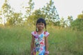 Adorable little girl laughing in a meadow - happy girl at sunset Royalty Free Stock Photo