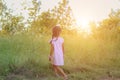 Adorable little girl laughing in a meadow - happy girl at sunset Royalty Free Stock Photo