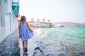 Adorable little girl at Little Venice the most popular tourist area on Mykonos island, Greece. Beautiful kid smile and Royalty Free Stock Photo