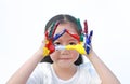 Adorable little girl looking through her triangle colorful hands painted over white background