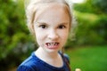 Adorable little girl making funny faces on beautiful summer day Royalty Free Stock Photo