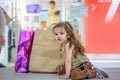 Adorable little girl at the market with shopping bags. Royalty Free Stock Photo