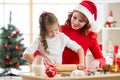 Adorable little girl and mother baking Christmas cookies Royalty Free Stock Photo