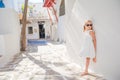 Adorable little girl at old street of typical greek traditional village Royalty Free Stock Photo