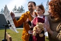 Adorable little girl painting picture with parents outdoors