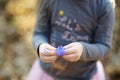 Adorable little girl picking the first flowers of spring in the woods on beautiful sunny spring day Royalty Free Stock Photo