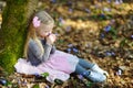 Adorable little girl picking the first flowers of spring in the woods on beautiful sunny spring day Royalty Free Stock Photo