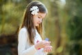 Adorable little girl picking the first flowers of spring in the woods on beautiful sunny spring day Royalty Free Stock Photo