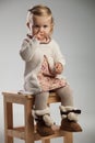 Adorable little girl picking her nose while sitting Royalty Free Stock Photo