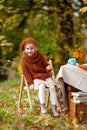 Adorable little girl on picnic in autumn park. Cute little girl  having tea party outside in the autumn garden.   Happy childhood Royalty Free Stock Photo