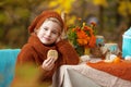 Adorable little girl on picnic in autumn park. Cute little girl  having tea party outside in the autumn garden.   Happy childhood Royalty Free Stock Photo