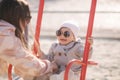 Adorable little girl play with her mom in the playground. Mom and daughter spend time together in Mother`s Day. Happy Royalty Free Stock Photo