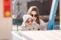 Adorable little girl play with her mom in the playground. Mom and daughter spend time together in Mother`s Day. Happy Royalty Free Stock Photo