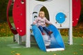 Adorable little girl on playground on a fall day Royalty Free Stock Photo