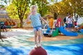 Adorable little girl on playground on a sunny day Royalty Free Stock Photo