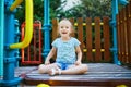 Adorable little girl on playground on a sunny day Royalty Free Stock Photo