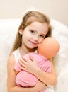 Adorable little girl playing with a doll Royalty Free Stock Photo