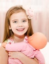 Adorable little girl playing with a doll Royalty Free Stock Photo