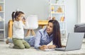 Adorable girl playing with glasses while her mom doing online freelance job at home. Working from home and parenting