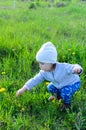 Adorable little girl playing on meadow in the countryside